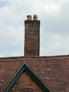 The historic chimney rising above the tiled roof of The Merchant’s House