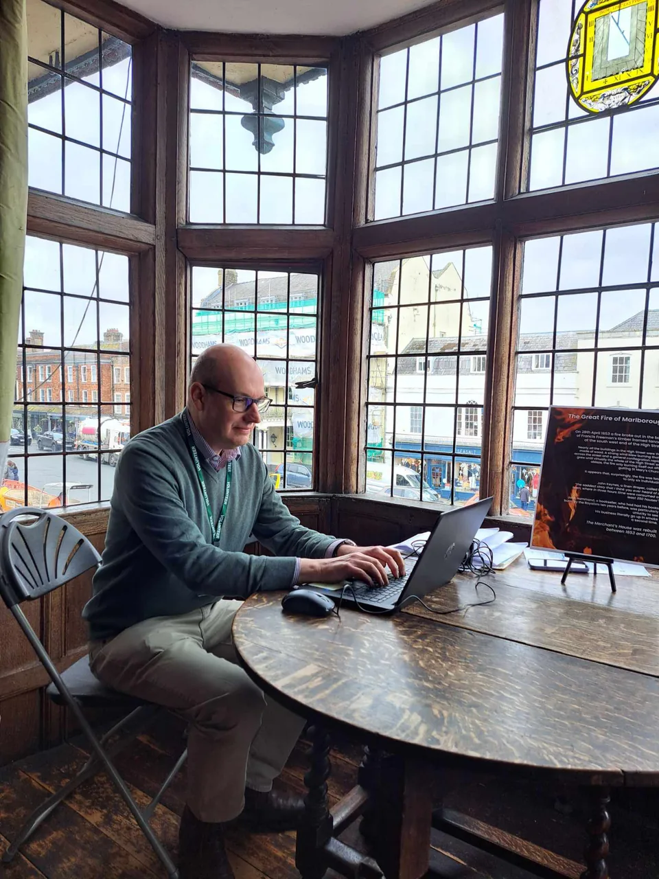 A researcher working beside a historic window
